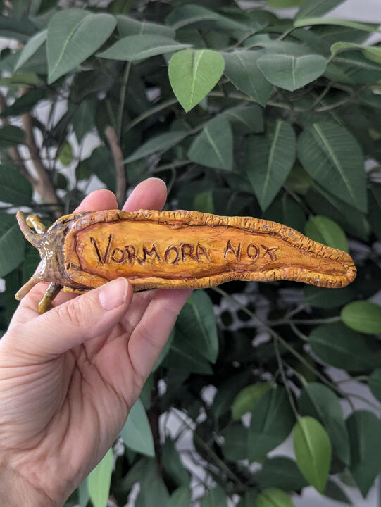 Banana slug clay sculpture painted with acrylic and sealed with gloss varnish